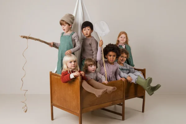 Kids wearing the new MarMar clothing together in a bed.