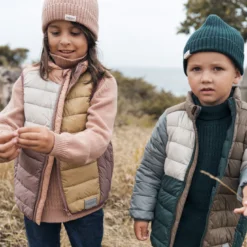 Two kids wearing MarMar clothing in Denmark in nature.